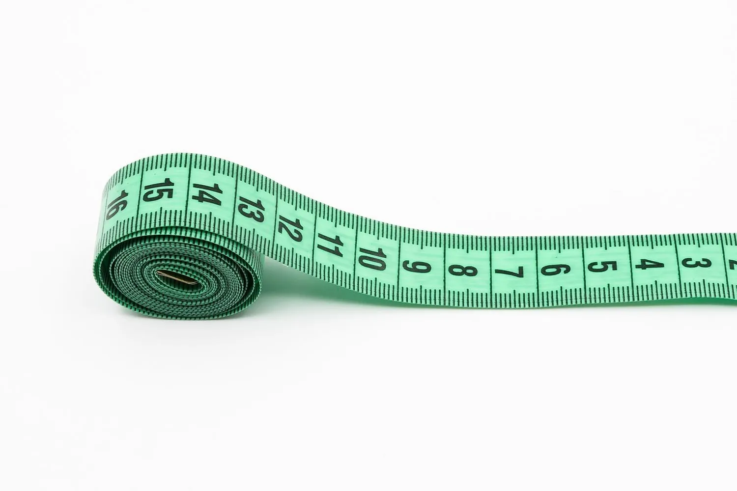 A tailor's measuring tape unrolled on a work surface