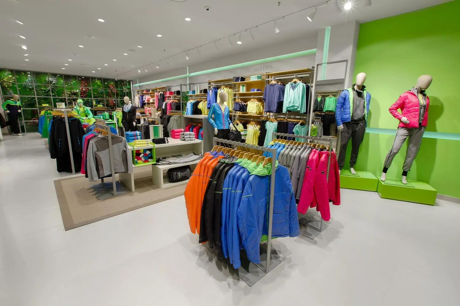 Sportswear on rails and mannequins inside a brightly lit store