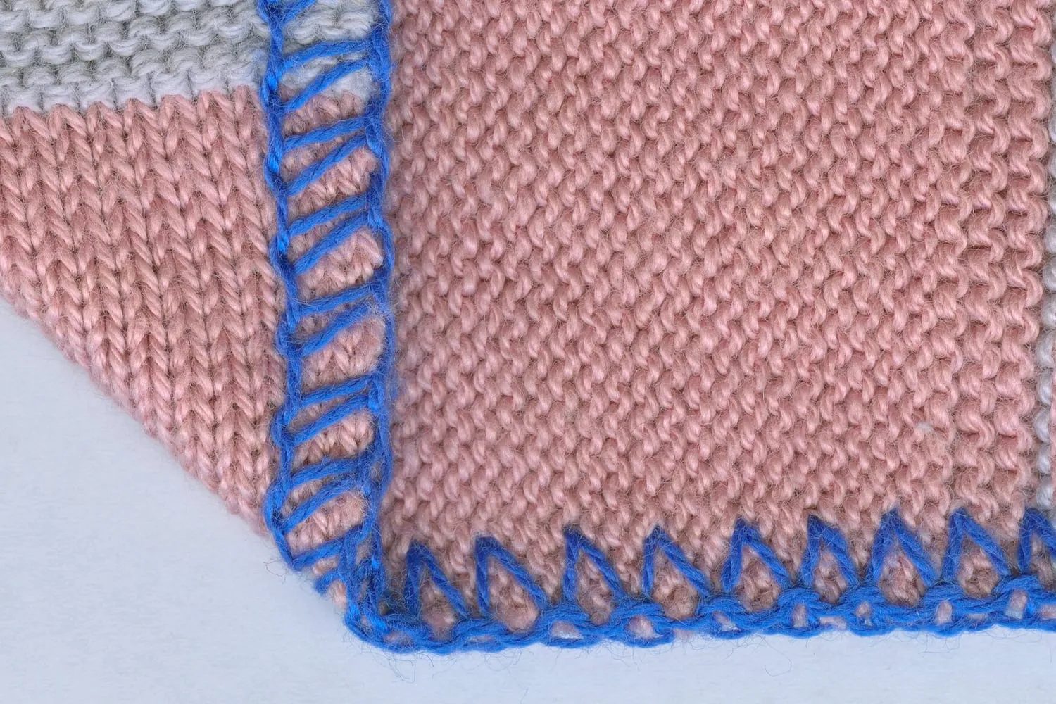 An overlocked seam joining two pieces of knitted fabric